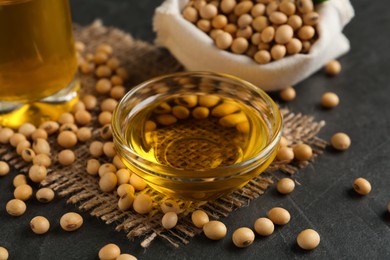 Composition with soybean oil on grey table, closeup