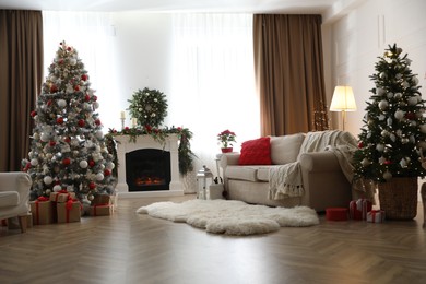 Photo of Festive living room interior with Christmas trees and fireplace