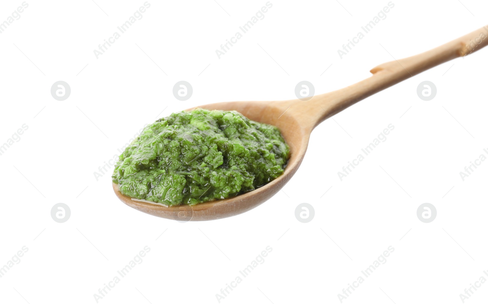 Photo of Spoon of tasty pesto sauce isolated on white