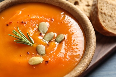 Bowl of tasty sweet potato soup on table, closeup