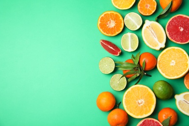 Photo of Different citrus fruits on color background, top view. Space for text