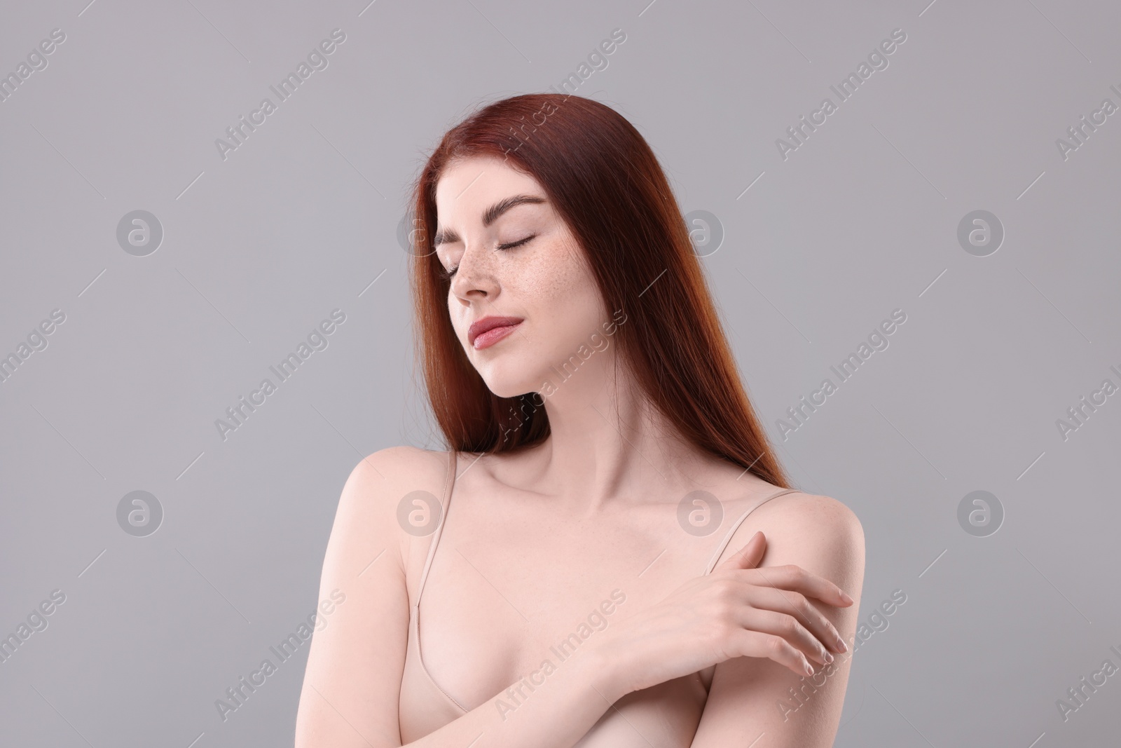 Photo of Portrait of beautiful woman on grey background