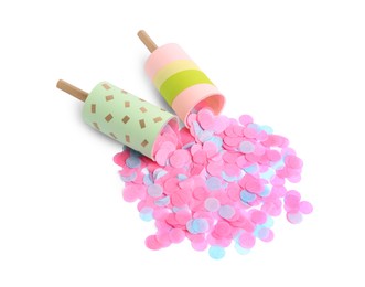 Photo of Colorful confetti with bright party crackers isolated on white, above view