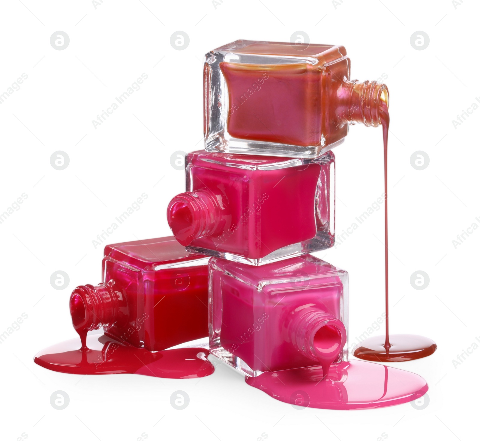 Photo of Color nail polishes dripping from bottles isolated on white