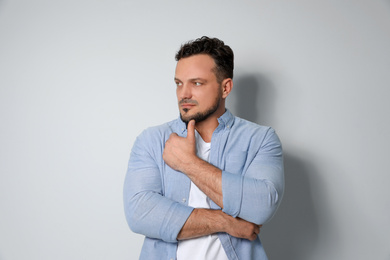 Photo of Portrait of handsome man on light grey background