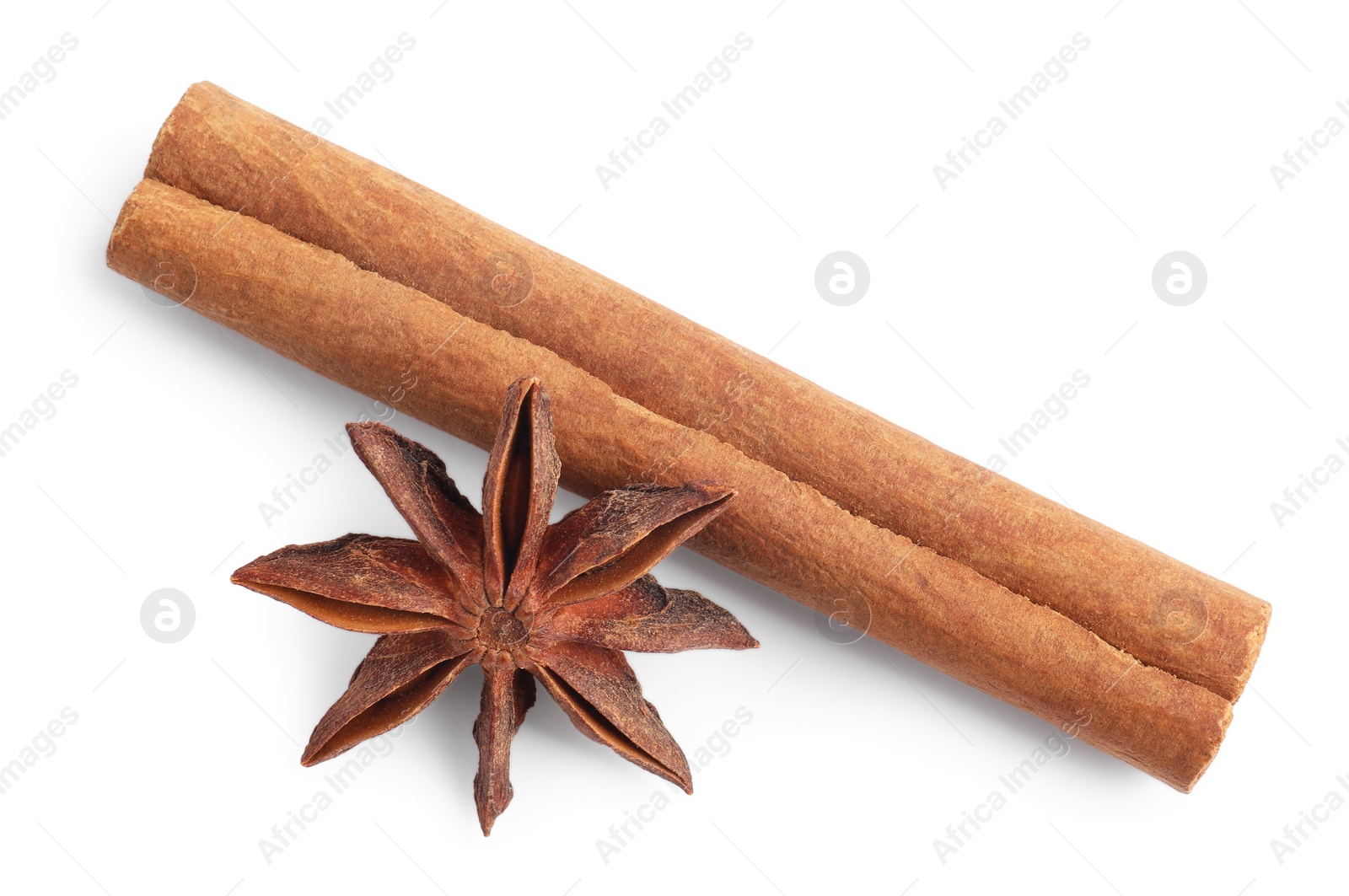 Photo of Aromatic cinnamon stick and anise star isolated on white, top view