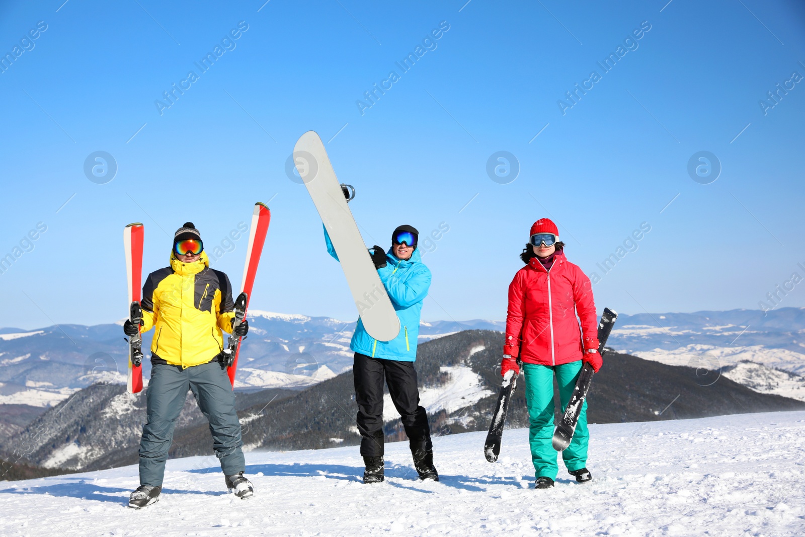 Photo of Friends with equipment at ski resort. Winter vacation