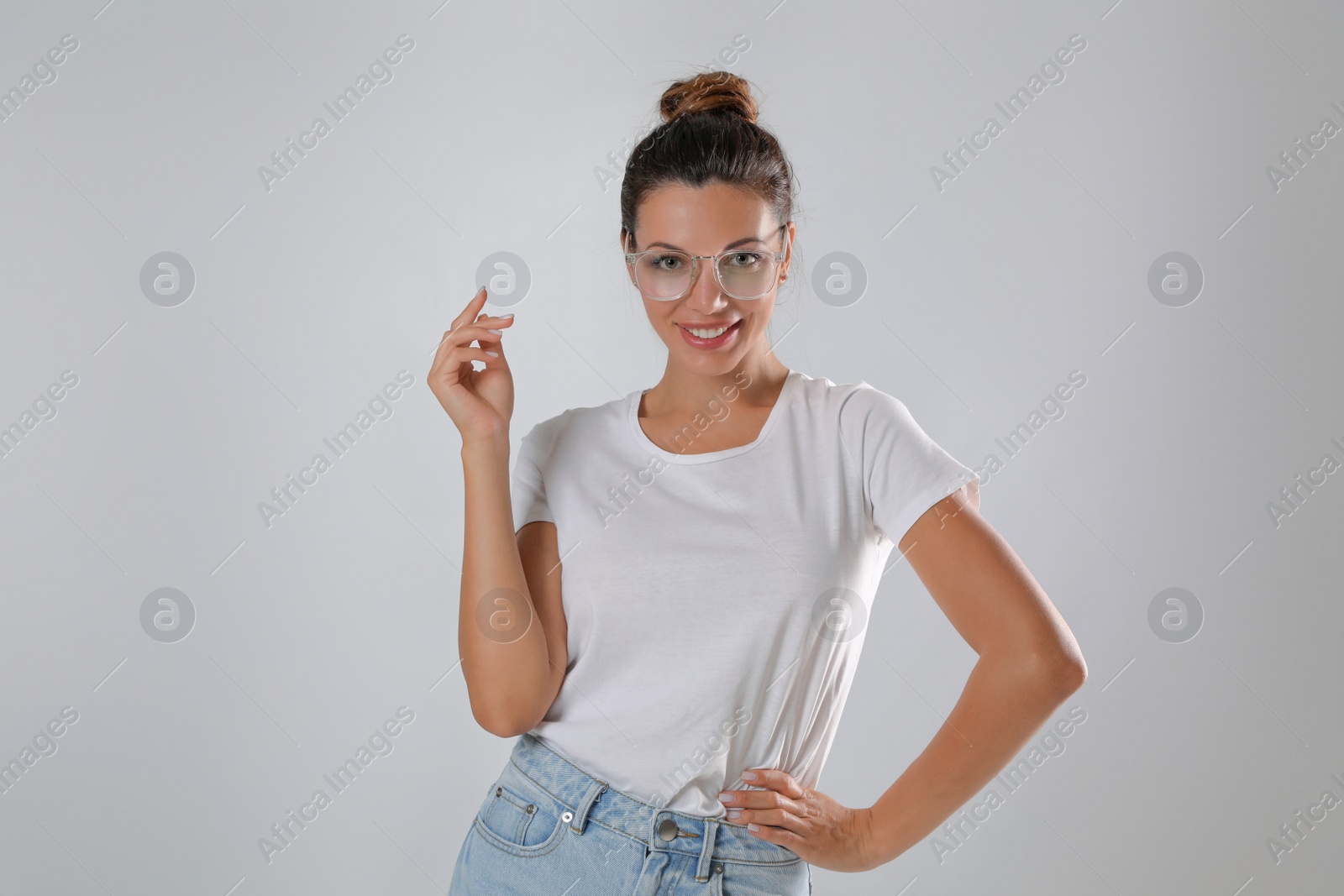 Photo of Beautiful woman in eyeglasses on white background