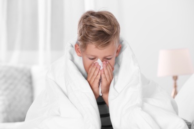Photo of Ill boy suffering from cough at home