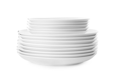 Photo of Stack of clean plates isolated on white