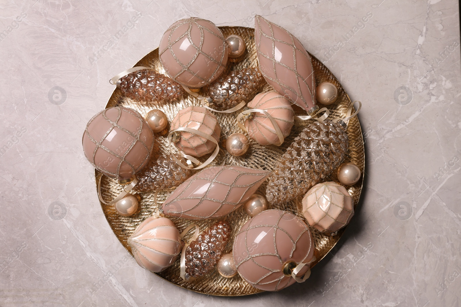 Photo of Christmas baubles on light grey table, top view