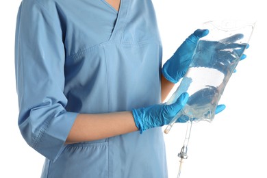 Nurse with IV infusion set on white background, closeup