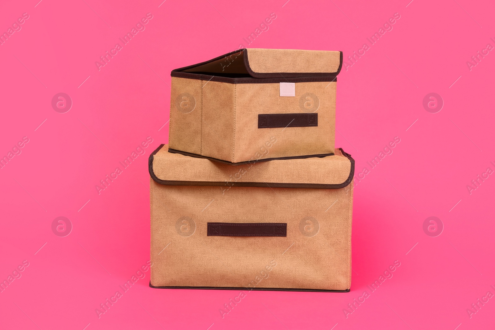 Photo of Two textile storage cases on pink background