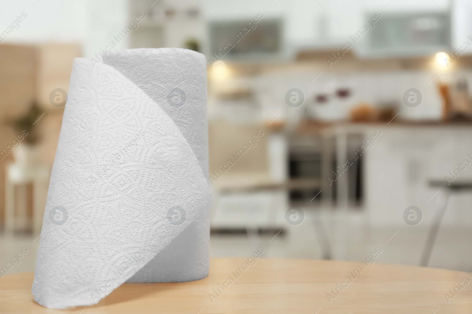 Photo of Roll of paper towels on table in kitchen, space for text