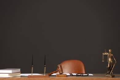 Judge's workplace with documents, table, chair and mallet. Space for text