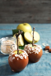 Photo of Delicious caramel apples on wooden background