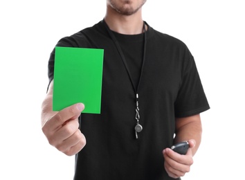 Photo of Football referee with stopwatch and whistle holding green card on white background, closeup