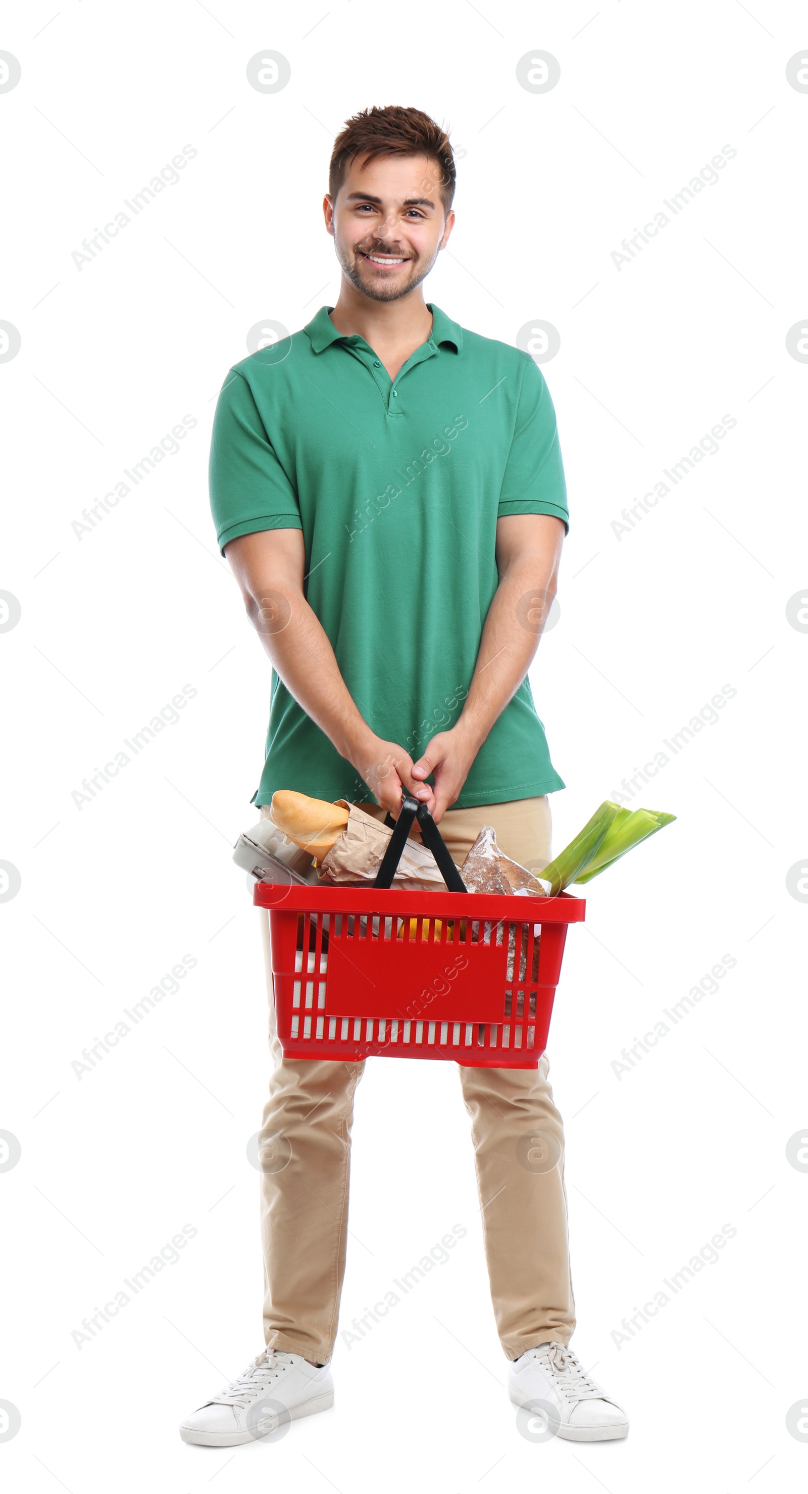 Photo of Young man with shopping basket full of products isolated on white