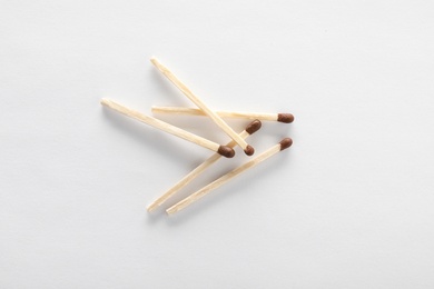 Photo of Wooden matches on white background, top view