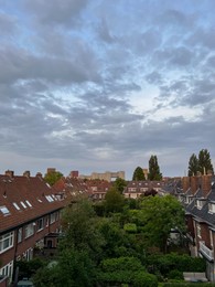 Picturesque view of city street with beautiful buildings on cloudy day