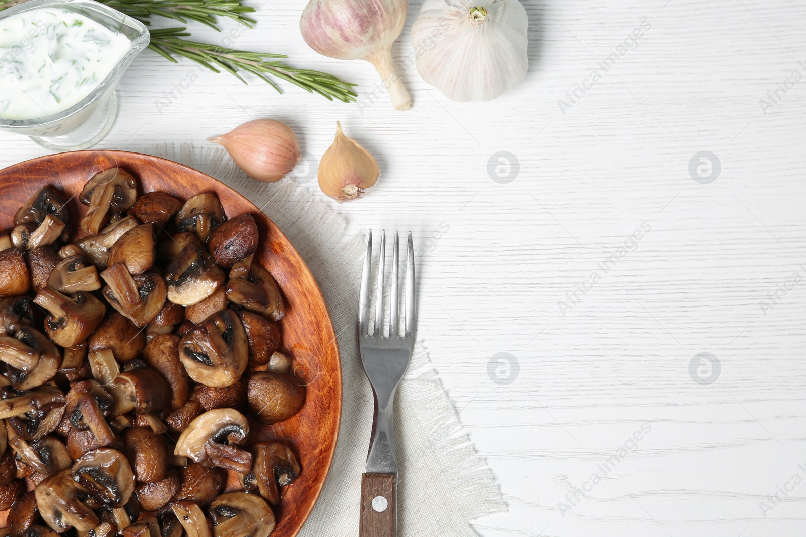 Photo of Flat lay composition with plate of fried mushrooms, sauce and space for text on white wooden background