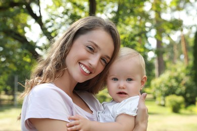 Photo of Mother with her cute baby spending time together outdoors