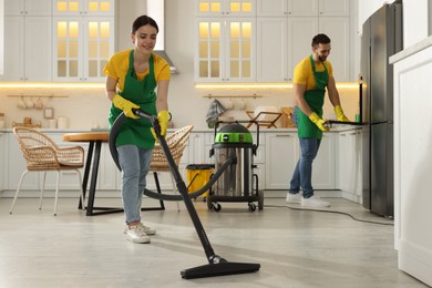 Photo of Professional janitors working in apartment. Cleaning service