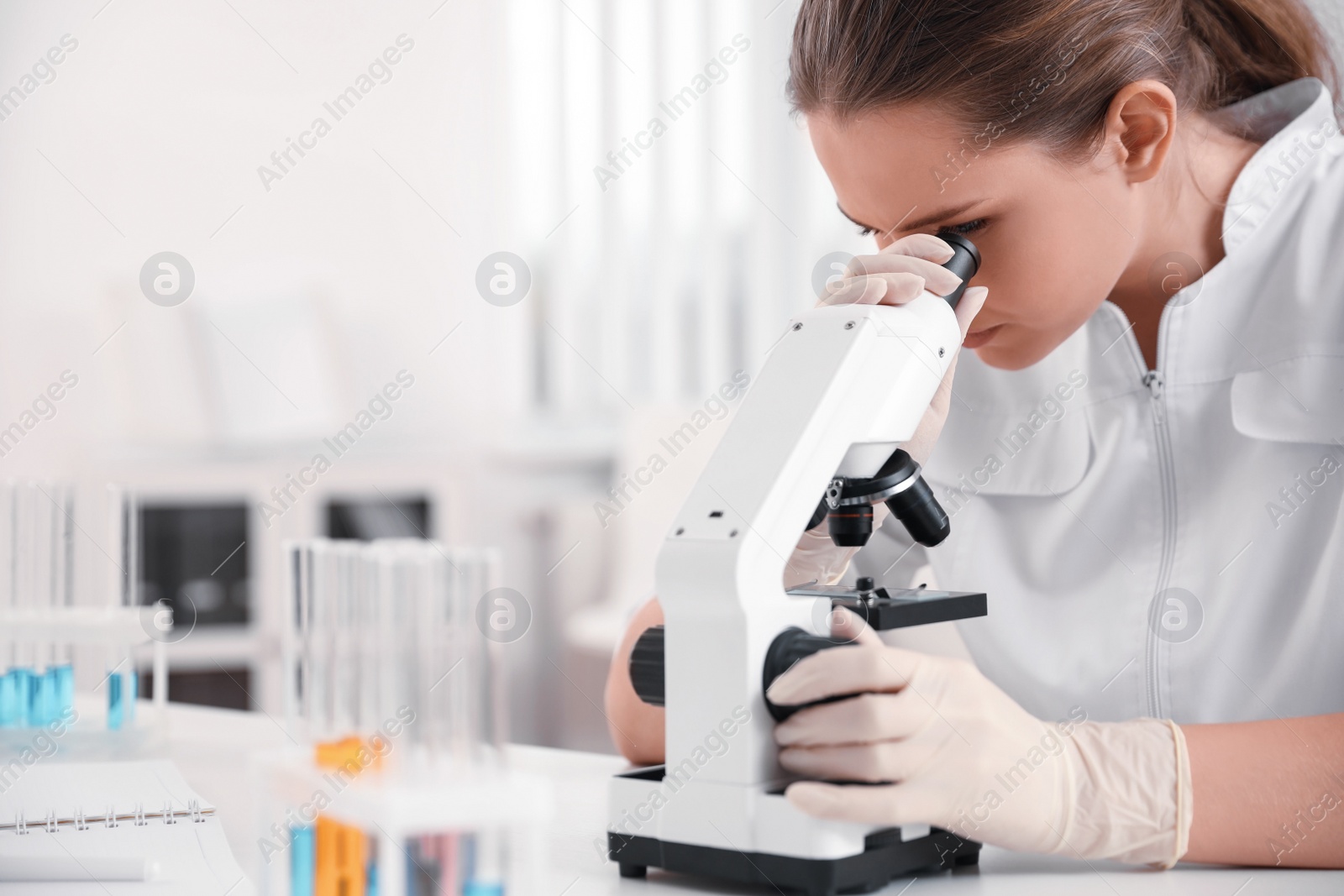 Photo of Scientist using modern microscope at table, closeup. Medical research