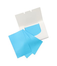 Photo of Open package of facial oil blotting tissues on white background, top view