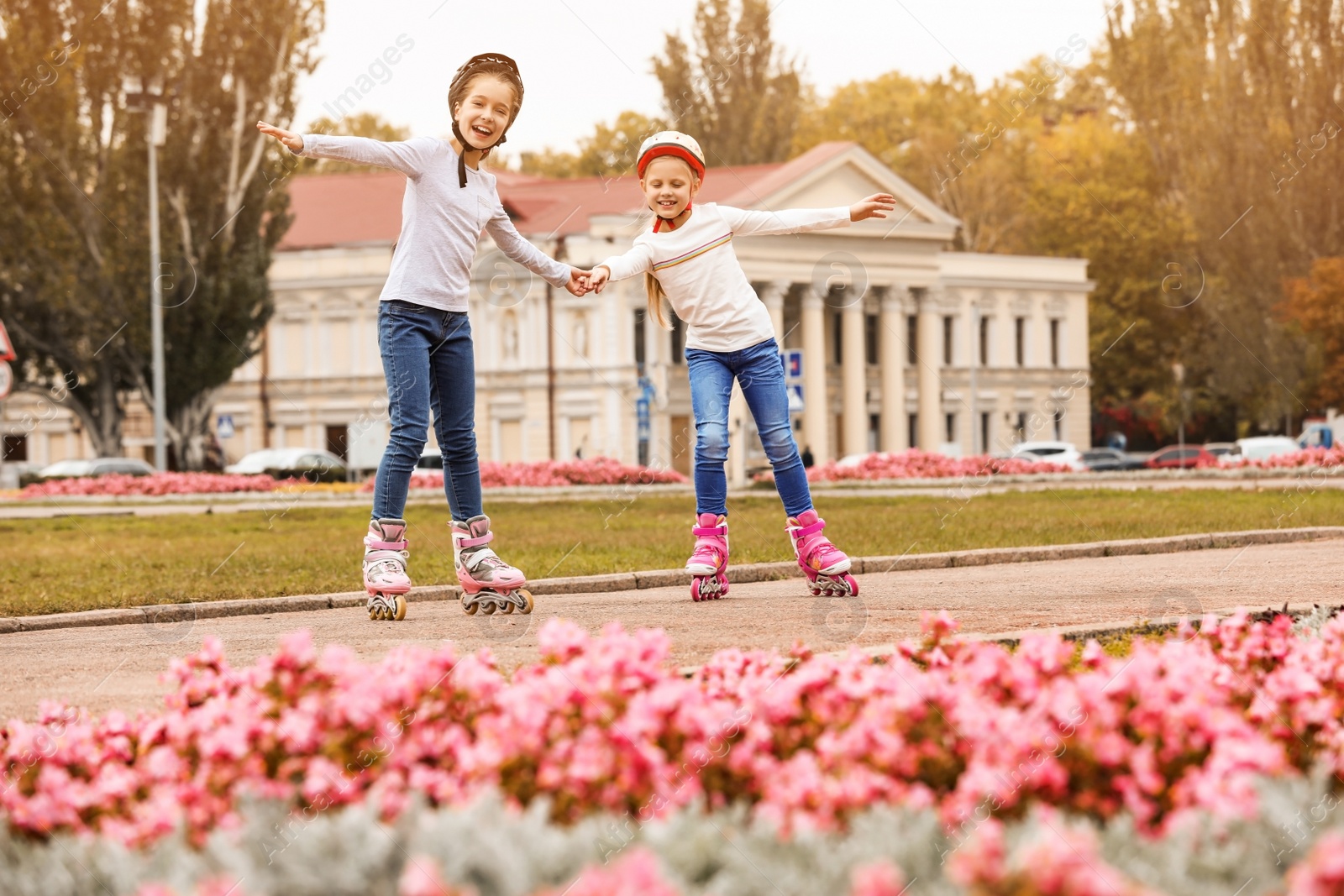 Photo of Happy children roller skating on city street