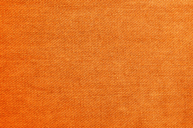 Texture of orange jeans as background, closeup