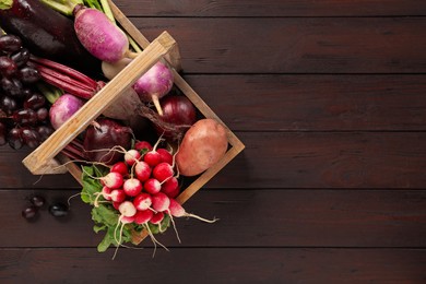 Different fresh ripe vegetables on wooden table, flat lay. Space for text