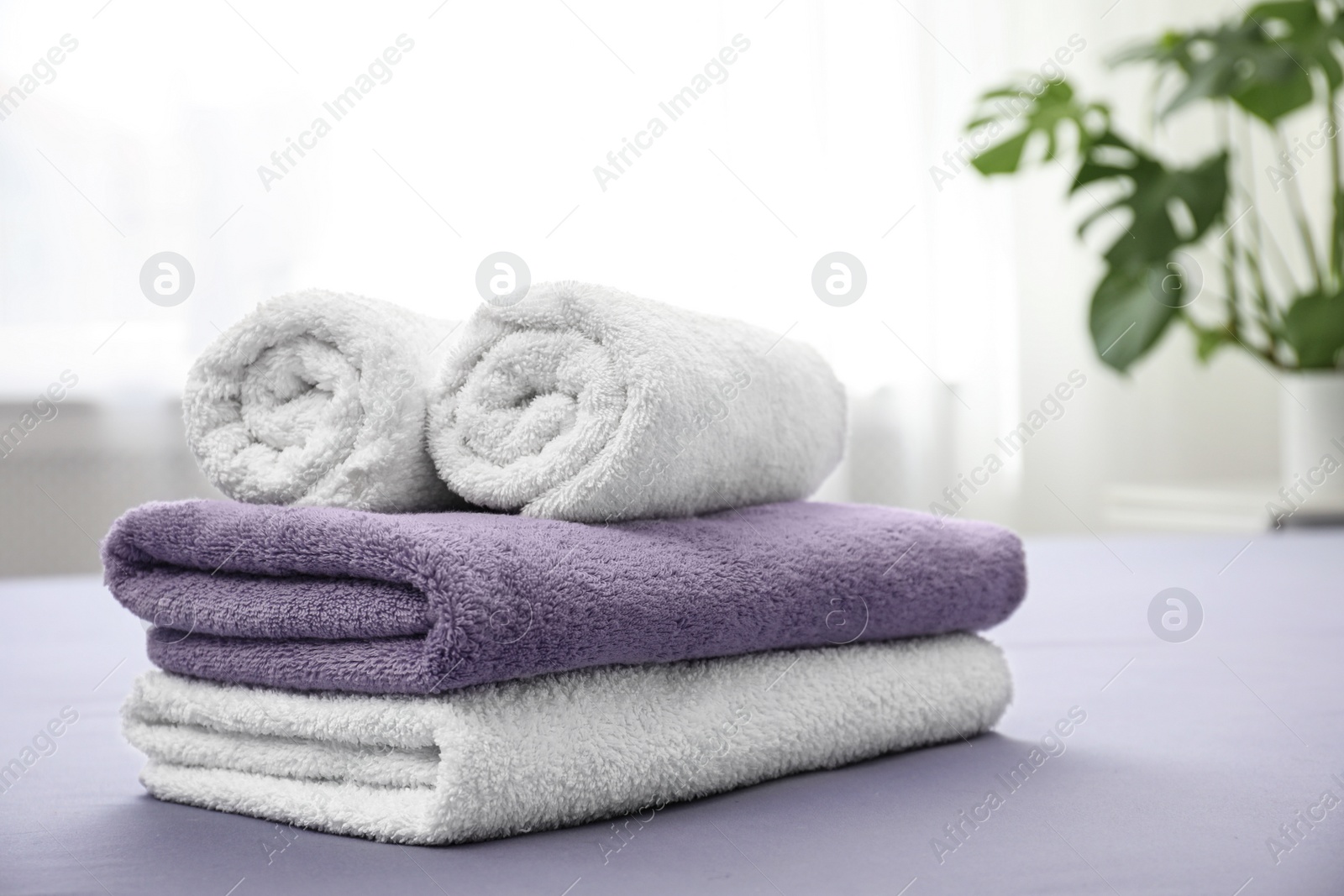 Photo of Soft clean towels on bed in room