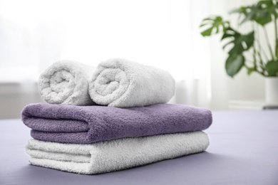 Photo of Soft clean towels on bed in room