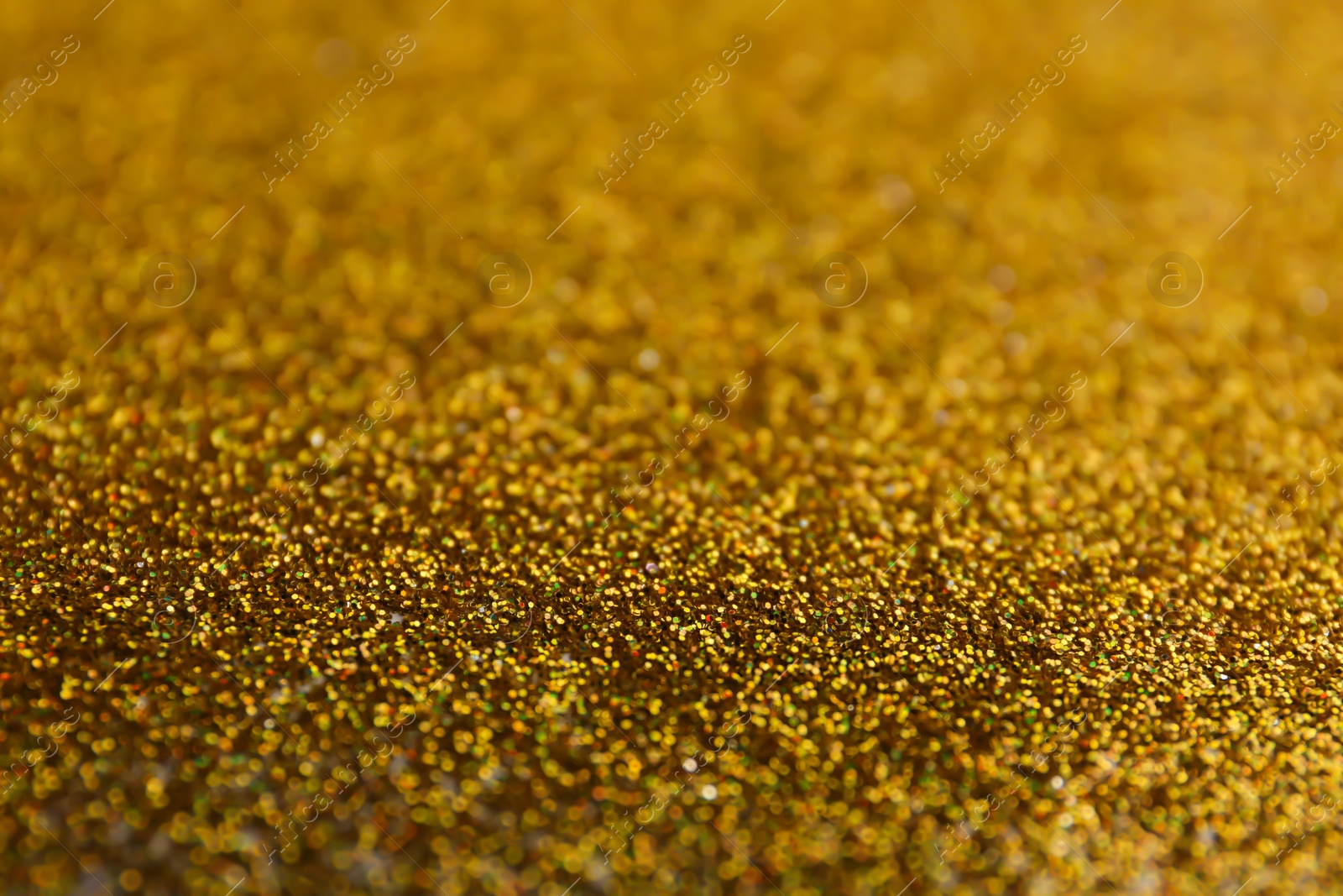 Photo of Closeup view of sparkling golden glitter background