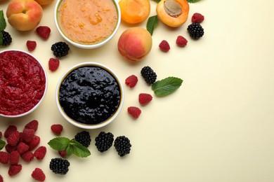 Different puree in bowls and fresh ingredients on beige background, flat lay. Space for text