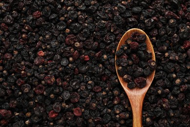 Photo of Spoon and tasty dried currants as background, top view. Space for text
