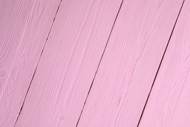 Photo of Texture of pink wooden surface as background, closeup