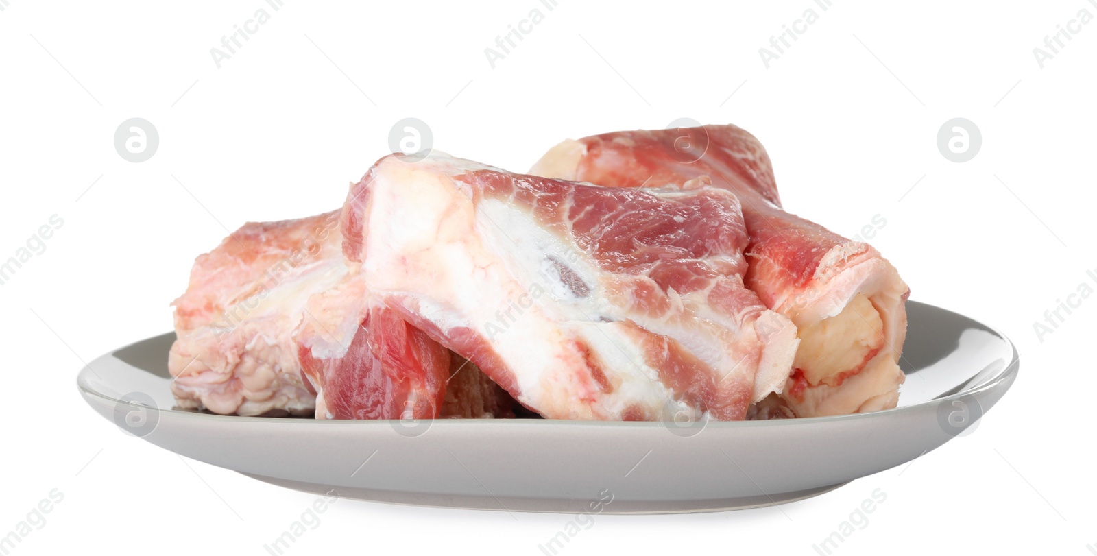 Photo of Plate with raw chopped meaty bones isolated on white