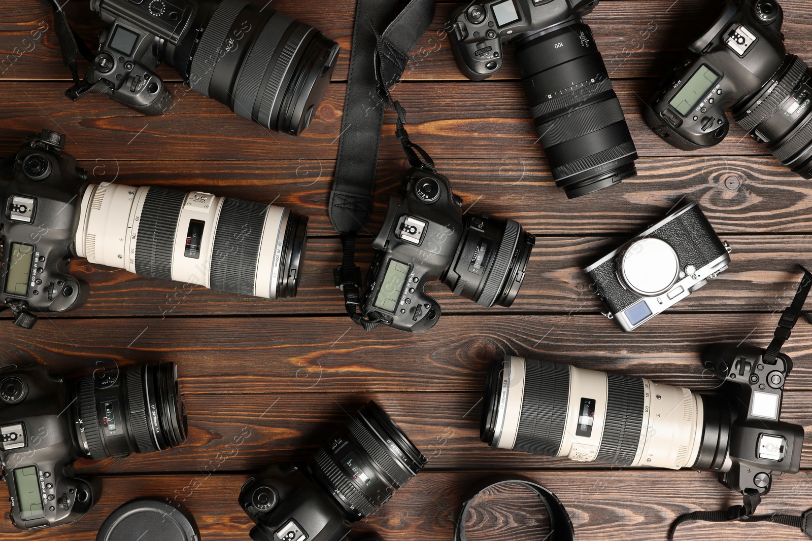 Photo of Modern cameras on wooden table, flat lay