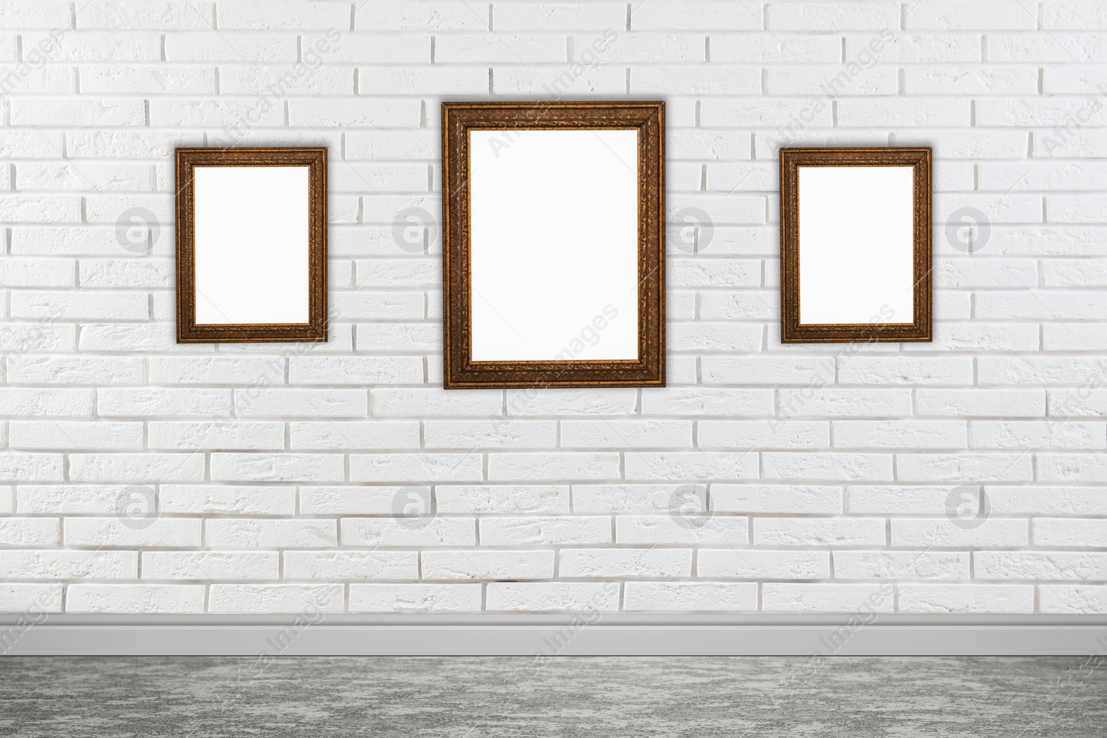 Image of Frames with empty canvases on brick wall in modern art gallery. Space for design