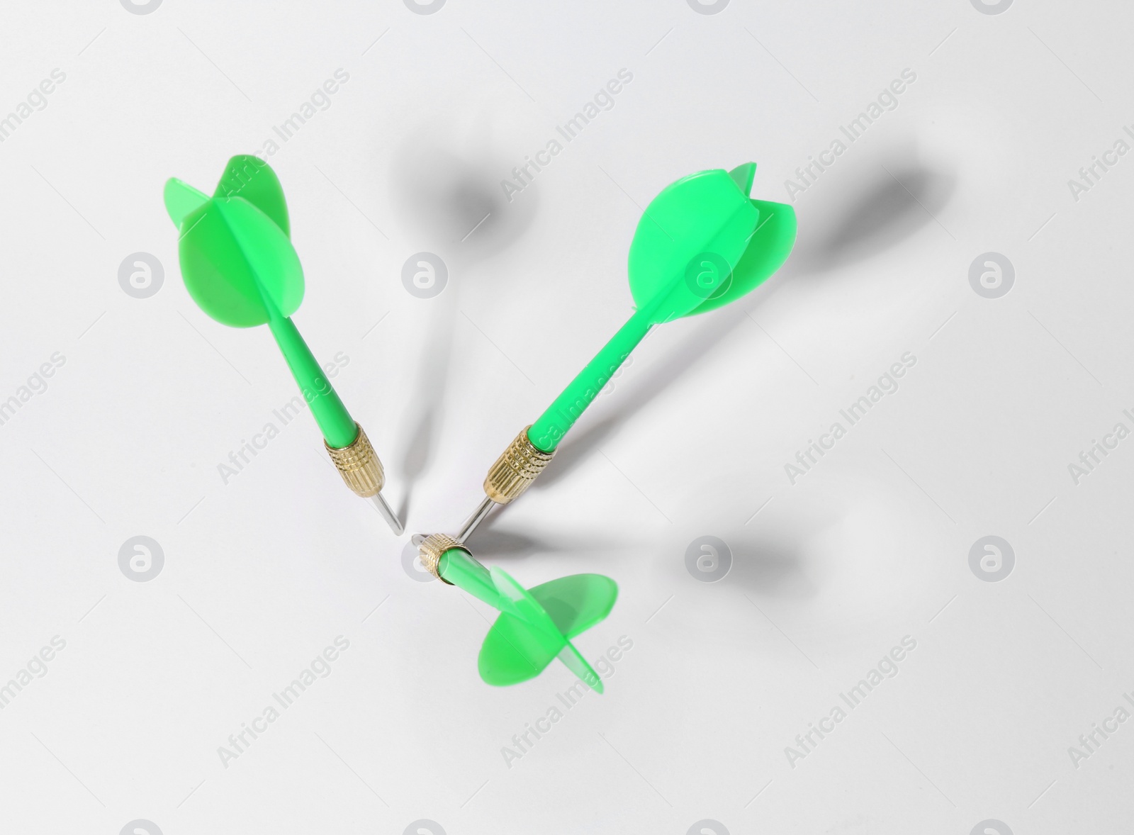 Photo of Green dart arrows for game on white background, above view