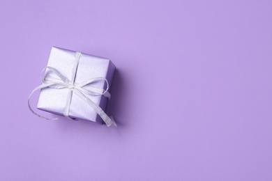 Photo of Beautiful gift box on color background, top view with space for text