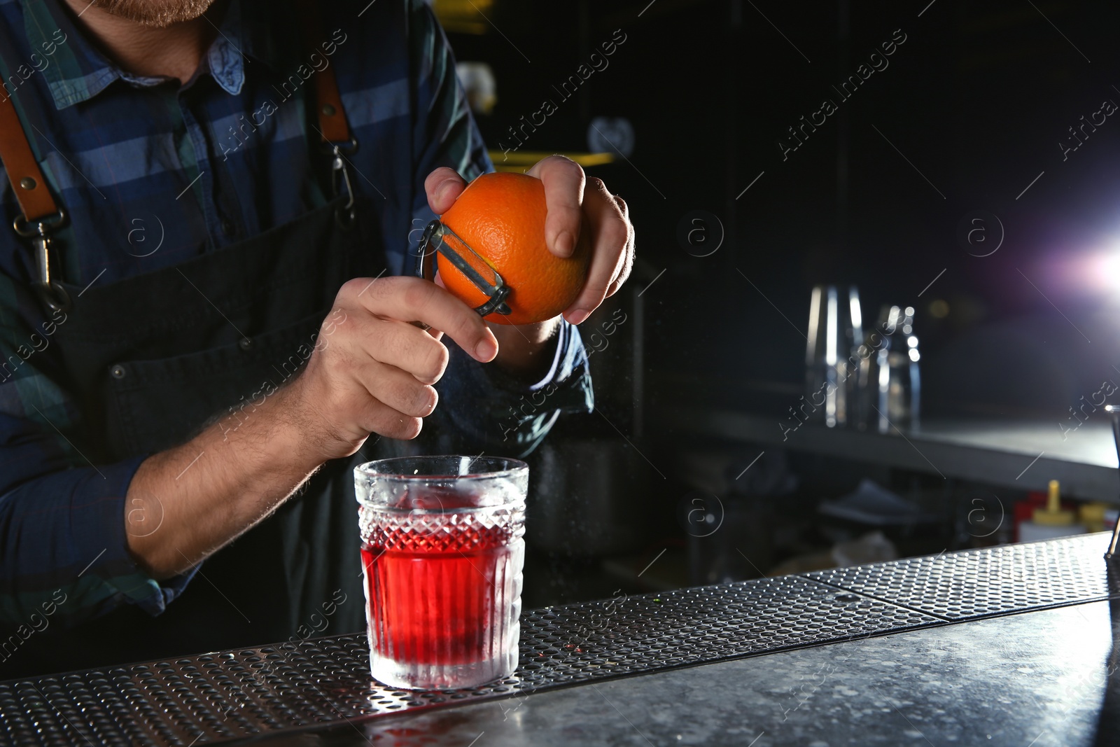 Photo of Barman making Red Russian cocktail at counter in pub, closeup. Space for text