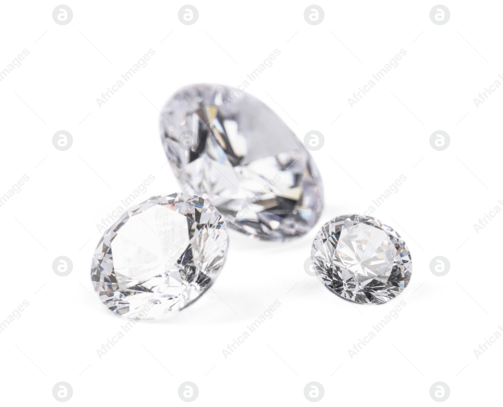 Photo of Three beautiful shiny diamonds isolated on white