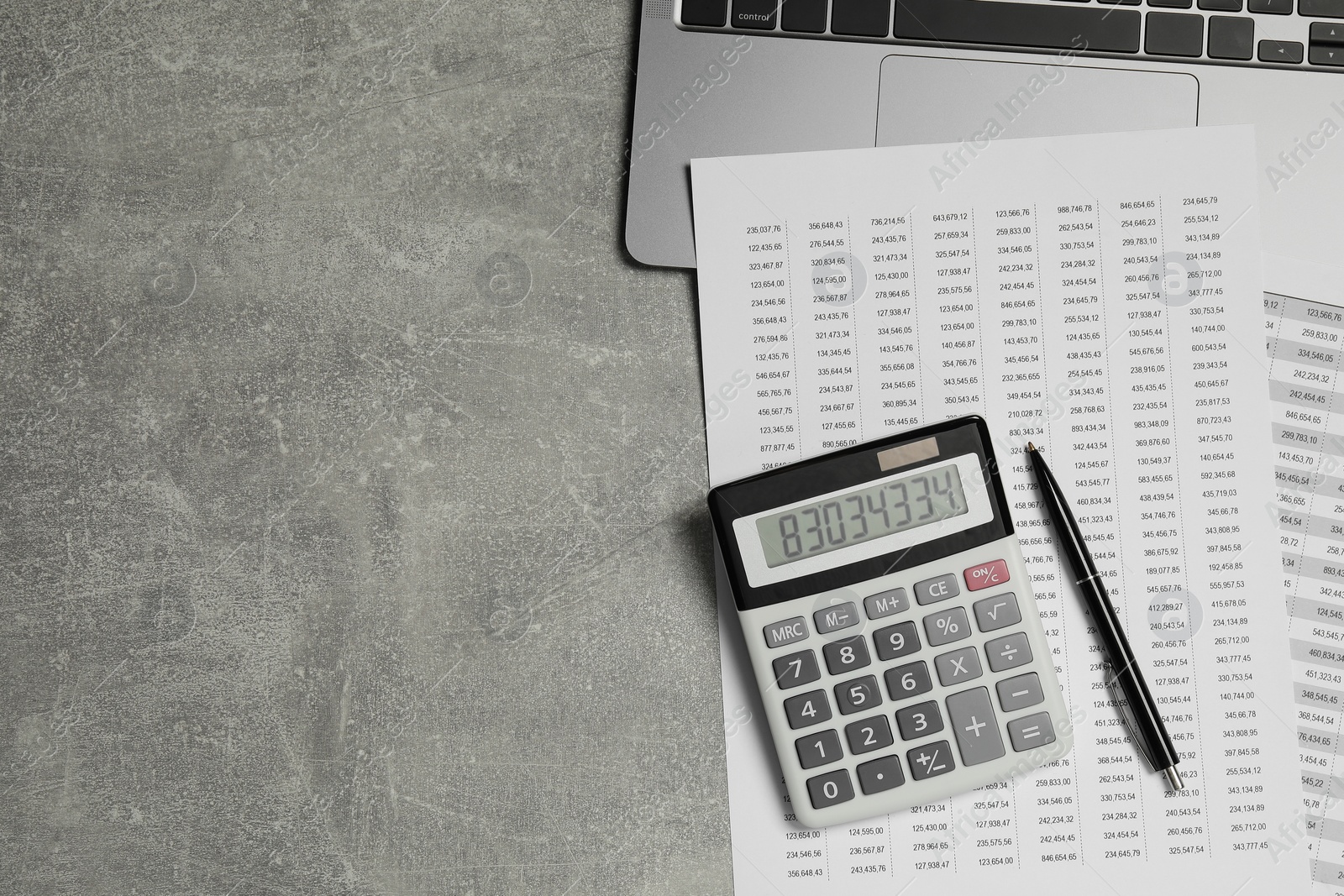 Photo of Calculator, laptop and financial documents on grey table, flat lay. Space for text