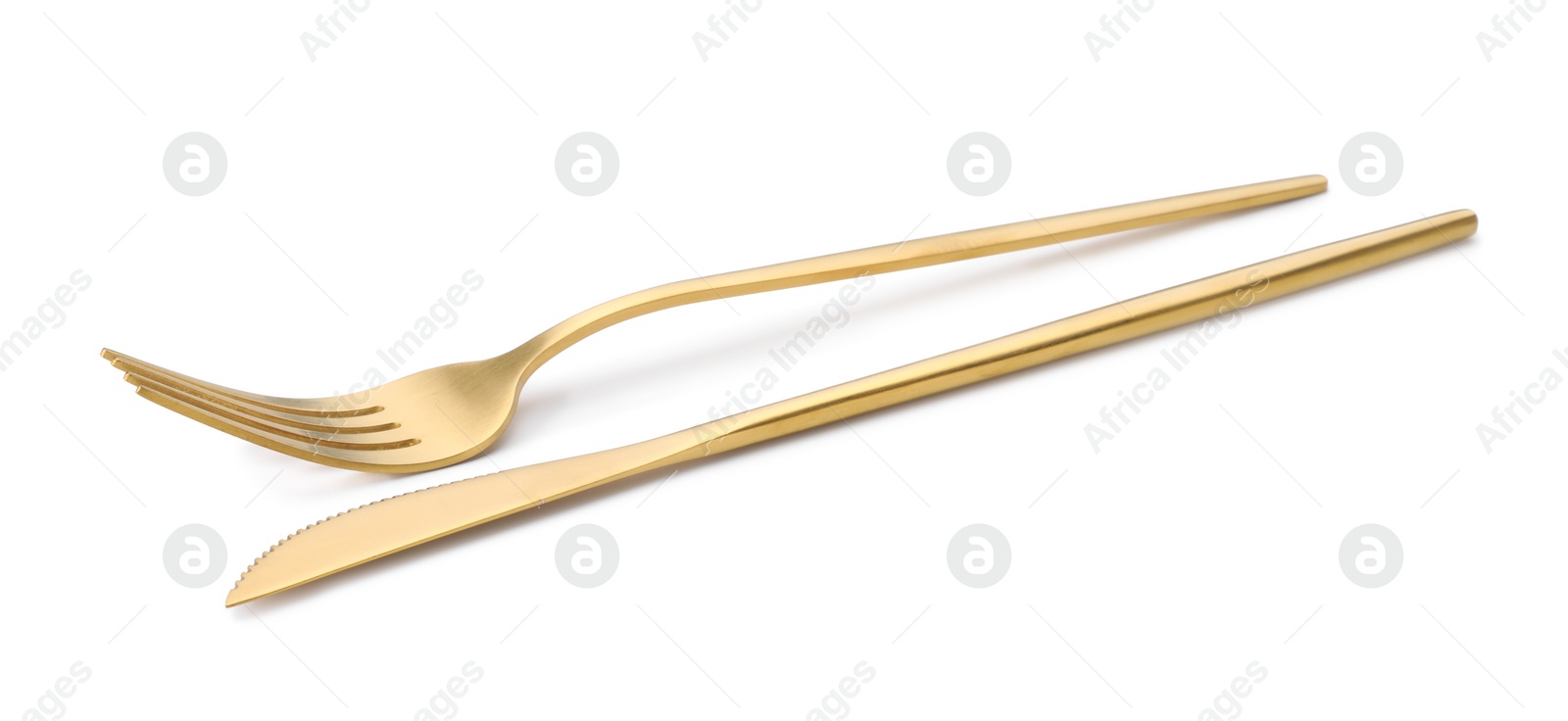 Photo of Shiny golden fork and knife isolated on white. Luxury cutlery