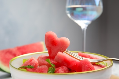 Photo of Delicious salad with watermelon in bowl, closeup