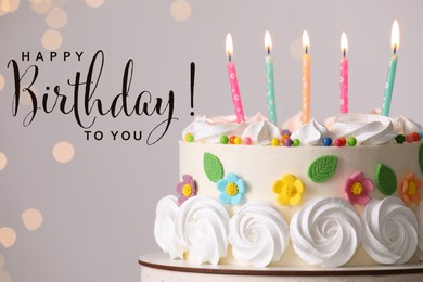 Happy Birthday! Delicious cake with party decor on stand against light grey background, closeup