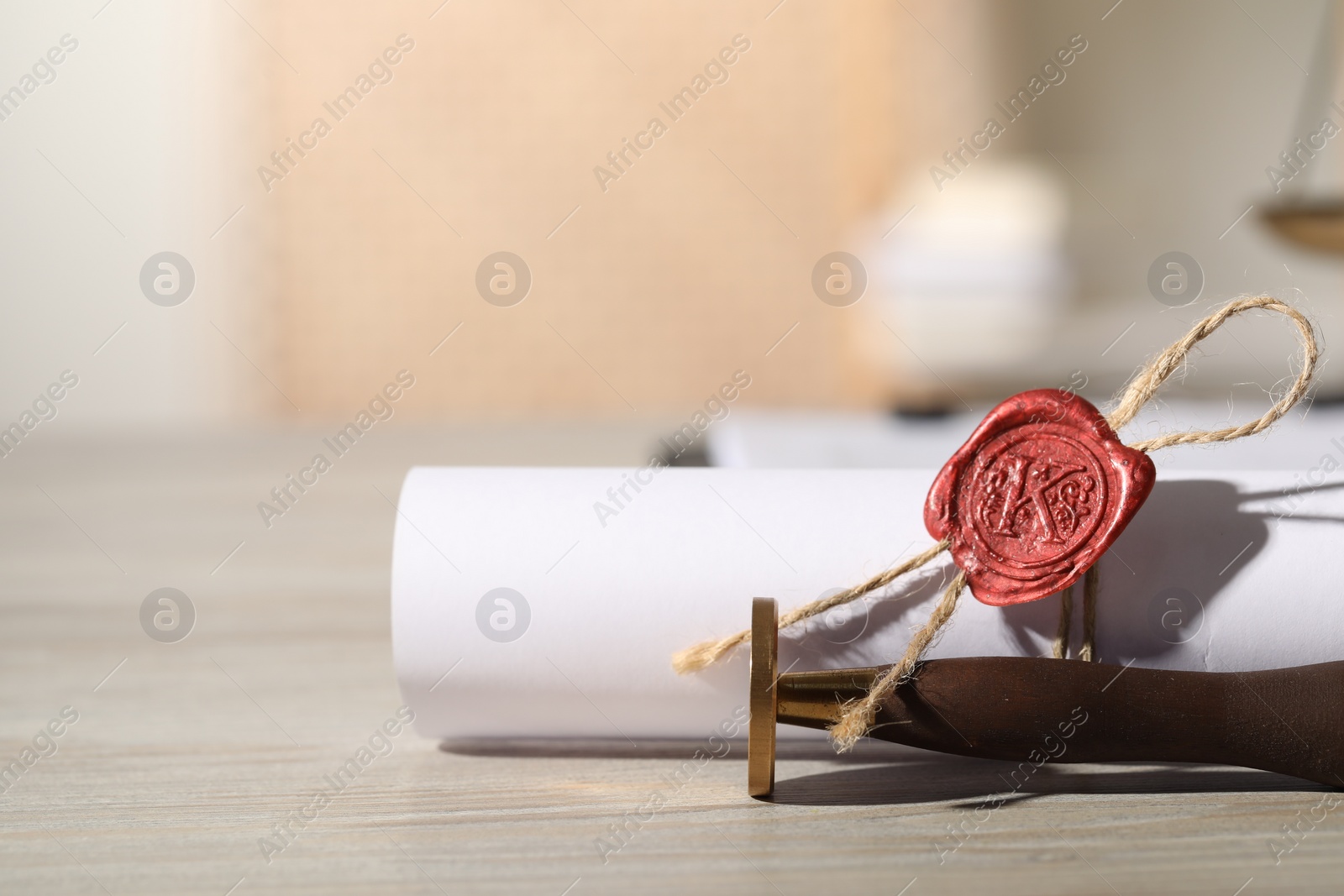 Photo of Notary contract. Sealed document and wax stamp on wooden table, closeup